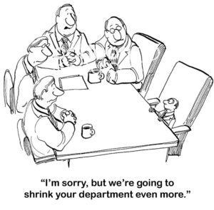 B&W accounting cartoon that shows a company that keeps shrinking the accounting department, it is very tiny now.