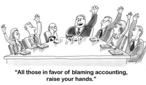 B&W accounting cartoon showing a meeting with all but one person having their hand in the air. "All those in favor of blaming accounting, raise your hands."