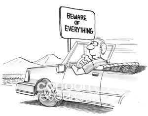 B&W cartoon of man driving a car and a sign "beware of everything".