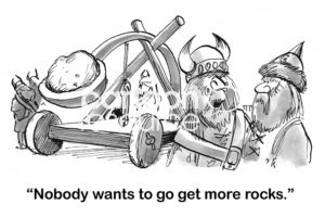 B&W boss cartoon showing Vikings with a trebuchet and the boss Viking complaining that 'nobody wants to go get more rocks'.