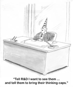 B&W boss cartoon of a male boss with a thinking cap on saying into the phone, 'tell R&D I want to see them... and tell them to bring their thinking caps'.