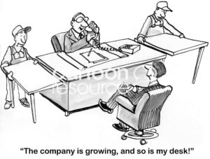 B&W boss cartoon showing an excited male boss saying, 'the company is growing and so is my desk'.