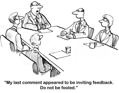 B&W boss cartoon showing workers in a meeting. The boss says to the workers, 'that last comment appeared to invite feedback, do not be fooled'.