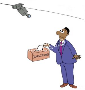 Color business cartoon showing a worried, black worker placing a suggestion in the Suggestion Box. The company has a video camera pointed at the Suggestion Box.