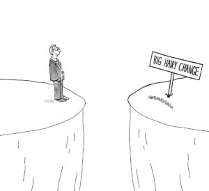 B&W change cartoon showing a businessman looking across a chasm towards 'big hairy change'.
