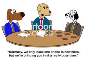 Color interview cartoon showing three worker dogs. One has 5 mobile phones in front of him. The HR boss says to the dog, 'normally we only issue one phone to new hires, but we're bringing you in at a really busy time'.