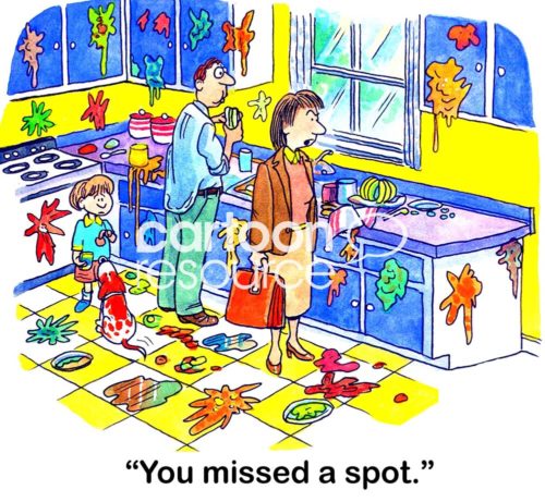 Business woman color cartoon showing a woman coming home from work. Her husband and children has made a huge mess in the family kitchen. The business woman says, 'you missed a spot'.