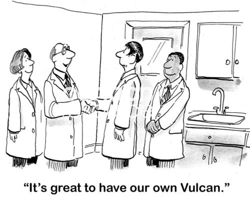 Office cartoon showing four people in a science laboratory. Two are shaking hands and one says, 'it's great to have our own Vulcan'. The 'Vulcan' has pointed ears.