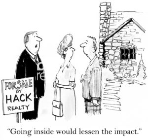 Real estate cartoon of a married couple with a male real estate agent beside a broken down house. The agent says to them, 'going inside would lessen the impact'.