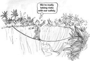 Leadership cartoon showing a worker man taking a risk by walking a tightrope over a deep gorge.