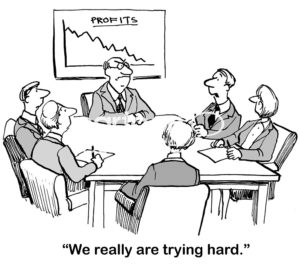 Finance b&w cartoon fo five people in a meeting with a boss and a chart showing declining profits. One says to the disgruntled boss, 'we really are trying hard'.