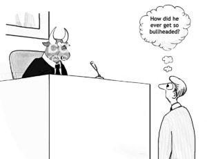 Legal B&W cartoon of a bull judge and a human male lawyer, in the courtroom, who is thinking 'how did he ever get so bullheaded'.