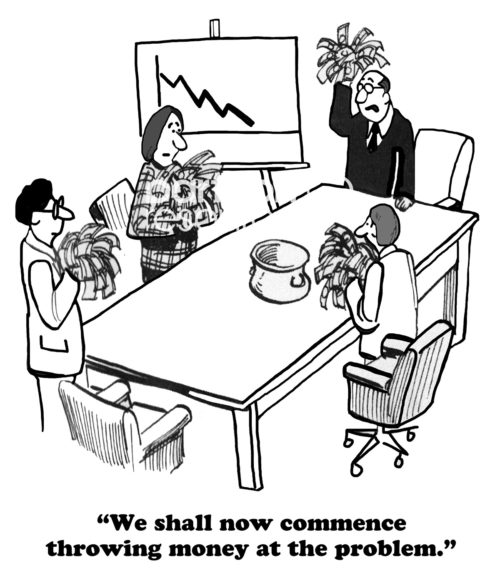 B&W business cartoon showing a chart with declining sales and the business people throwing bundles of money into a huge pot on the meeting table. One says, 'we shall now commence throwing money at the problem'.