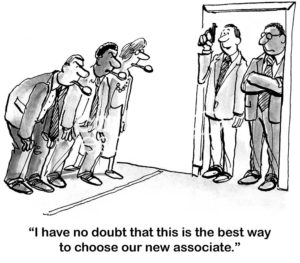 B&W interview cartoon showing that the company is not interviewing job candidates, rather they are selecting the candidate to hire based on a egg spoon race.