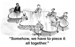 Teamwork cartoon showing a team sitting around a large puzzle piece, they "... have to piece it all together".