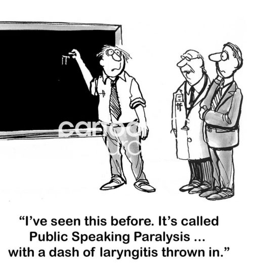 B&W office cartoon showing a doctor and a man looking at a third men starting to write on a board, but frozen in time. The doctor states, 'I've seen this before. It's called Public Speaking Paralysis... with a dash of laryngitis thrown in'.